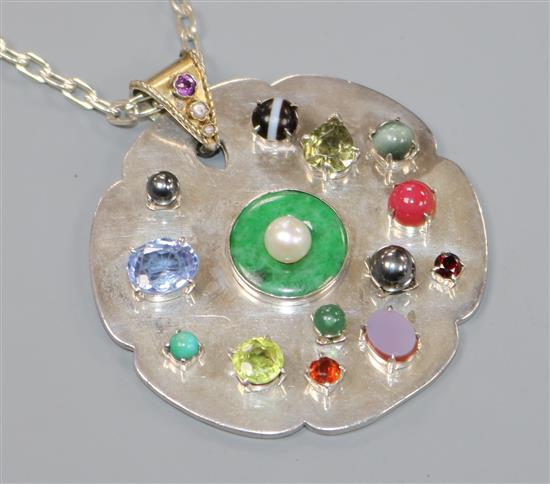 A bespoke white metal and multi gem set shaped circular pendant, on a white metal chain, pendant 52mm.